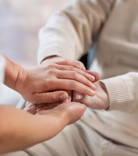 doctor-holding-hands-with-senior-patient_23-2148962319